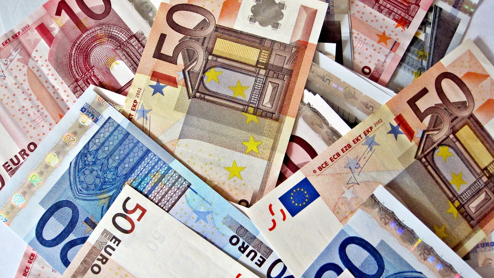 A spread of international banknotes from many countries, representing cross-border money transfers